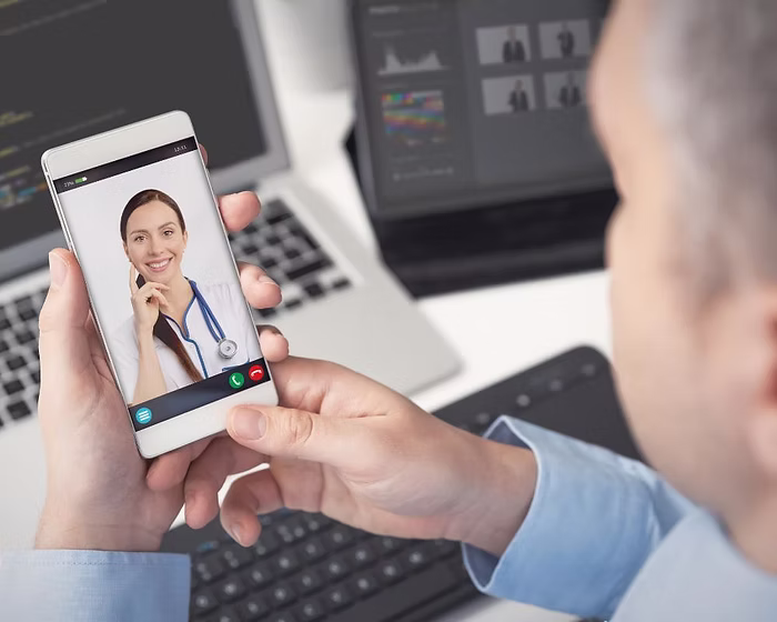 A man having a video call with his doctor.